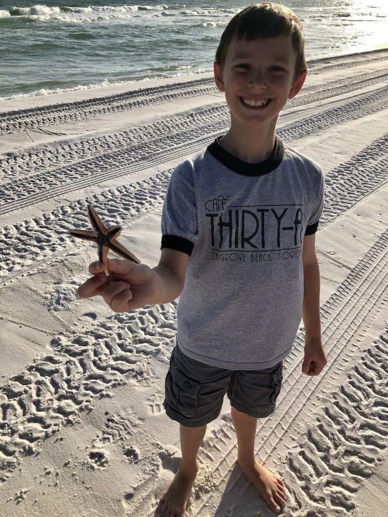 my son is out on the 30a holding a starfish